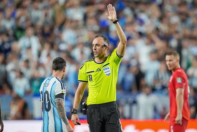 Referee João Pinheiro reviewing the incident 