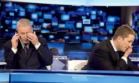 Football journalist working on transfer deadline day with laptops, phones, and live football news feeds